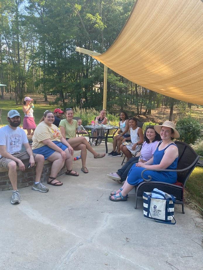 group of pediatric residents sitting at patio at outdoor event